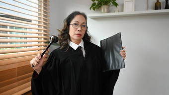 自信成熟的女法官<strong>律师律师</strong>袍礼服统一的槌子锤锤法律正义概念
