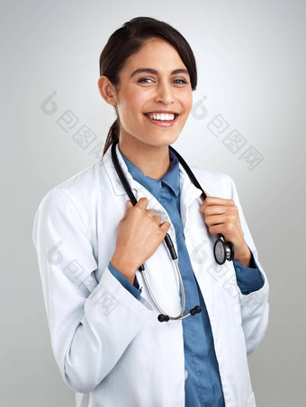 承诺提供异常护理工作室肖像自信年轻的医生摆姿势灰色背景