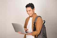 英俊的年轻的学生移动PC携带背包孤立的白色背景