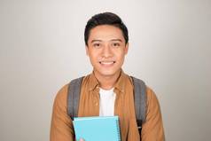 肖像微笑年轻的大学亚洲学生书背包白色背景