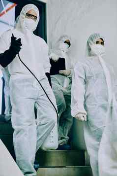 梦想病毒战斗团队集团医疗保健工人穿有害物质西装工作控制爆发