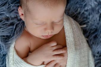 新生儿婴儿男孩床上出生孩子睡觉白色针织毯子孩子们睡眠特写镜头