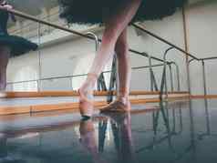 芭蕾舞女演员芭蕾舞尖端延伸巴利健身房女人练习跳舞工作室工作年轻的女孩