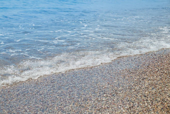 卵石海滩Azure海<strong>水纹</strong>理<strong>背景</strong>清晰的海水卵石海滩纯水石头海岸海岸线用石头砸海岸华丽的海景假期夏天天堂