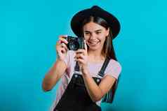 年轻的漂亮的女人需要图片数码单反相机相机蓝色的背景工作室女孩微笑有趣的摄影师