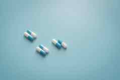 双white-blue抗生素胶囊药片蓝色的背景抗生素药物处方药物药理学推荐剂量概念制药行业医疗医疗保健概念
