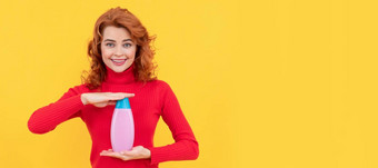 快乐的红色头发的人女人卷曲的染色头发展示身体护理产品洗发水广告