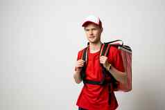 交付男人。红色的统一的携带热背包完整的食物食品杂货客户食物交付服务