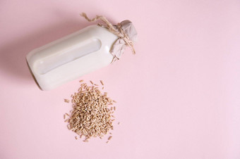 堆燕麦燕麦瓶植物基于<strong>有机</strong>健康的燕麦牛<strong>奶粉</strong>红色的表面素食主义者有益健康的乳制品免费的喝