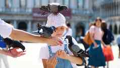 威尼斯意大利7月视图快乐孩子女孩旅游持有鸽子喂养玩有趣的广场三马可马克的教堂夏天一天
