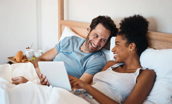 笑结婚了夫妇平板电脑床上看有趣的喜剧电影电影周末在室内首页爱的微笑浪漫的丈夫妻子模因社会媒体