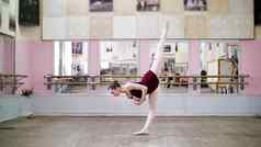 跳舞大厅年轻的芭蕾舞女演员黑色的紧身连衣裤执行大巴特曼回来提出了腿优雅芭蕾舞类