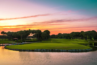 全景视图美丽的高尔夫球松树<strong>日落</strong>高尔夫球场球道湖松树
