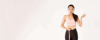 健身健康的生活方式幸福概念惊讶亚洲女孩饮食女运动员包装测量磁带腰深刻的印象失去重量锻炼