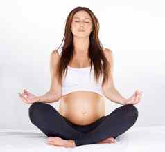幸福年轻的怀孕了女人莲花位置瑜伽例程