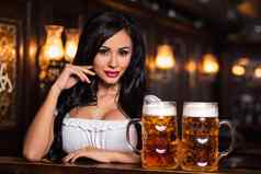 啤酒节浅黑肤色的女人女人持有啤酒杯子酒吧
