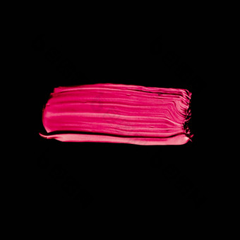 粉红色的口红刷中风纹理孤立的黑色的背景