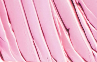 粉红色的化妆品纹理背景化妆护肤品化妆品产品奶油口红保湿霜宏奢侈品美品牌假期平铺设计