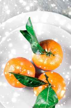 橘子Mandarines柑橘冬天假期时间柑橘类水果板发光的雪闪闪发光的平铺背景