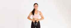 体育运动幸福活跃的生活方式概念微笑强大的苗条的亚洲健身女孩健身首页持有锻炼设备下蹲壶铃锻炼白色背景