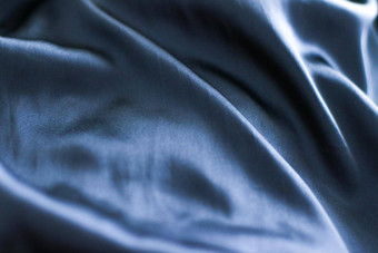 奢侈品黑暗蓝色的软丝绸平铺背景纹理假期魅力摘要背景