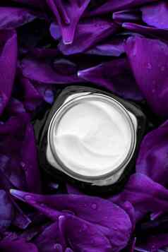 奢侈品脸奶油保湿霜面部皮肤紫色的花背景花散文水疗中心化妆品美乳状液护肤品品牌产品
