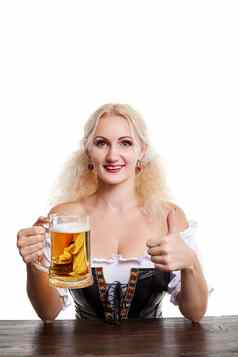 美丽的年轻的金发碧眼的女孩传统的服装饮料啤酒节啤酒斯坦