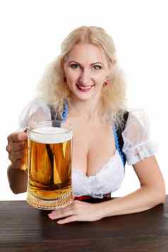 美丽的年轻的金发碧眼的女孩传统的服装饮料啤酒节啤酒斯坦