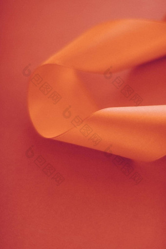 摘要卷曲的丝绸丝带橙色背景独家奢侈品品牌设计假期出售产品促销活动魅力艺术邀请<strong>卡</strong>背景