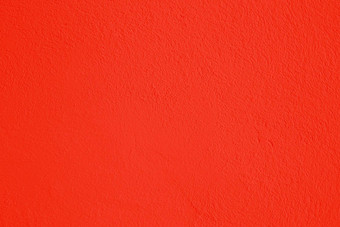 墙覆盖明亮的红色的不光滑的油漆