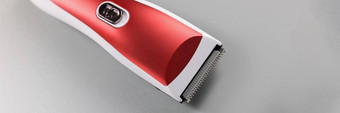 电头发机修剪头发红色的颜色设计灰色表面