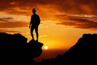 日落徒步旅行轮廓男人。前山冒险旅程非洲自由橙色<strong>天空</strong>的家伙站悬崖徒步旅行自然夏天晚上