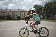 一边全身的活跃的运动孩子男孩保护体育头盔骑自行车城市沥青路