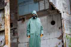 男人。保护面具保护服装检查危险区生态灾难危险的有毒区摧毁了房子