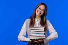 亚洲聪明的学生持有堆栈大学书大学图书馆蓝色的背景快乐女孩微笑快乐研究生