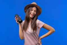 年轻的女人听音乐无线可移植的演讲者现代声音系统青少年女孩享受蓝色的工作室背景
