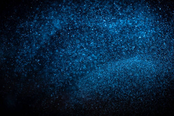 真正的蓝色的灰尘<strong>粒子</strong>黑色的背景闪闪发光的闪闪发光的散景覆盖复制空间