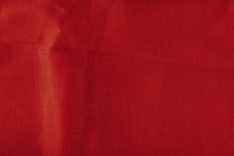 红色的亚麻织物纹理皱巴巴的亚麻织物折叠特写镜头