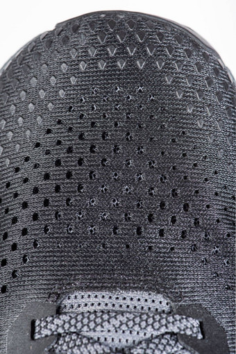 网织物体育鞋子灰色的颜色鞋子使网织物纺织纹理活跃的生活方式运行体育现代运行鞋子特写镜头