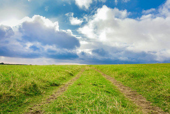 绿色国家路云背景田园视图农村路绿色字段蓝色的天空云景观绿色路径云蓝色的天空背景