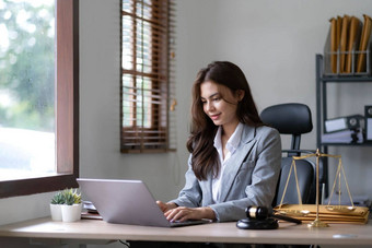 亚洲律师女人工作移动PC电脑法律办公室法律法律服务概念