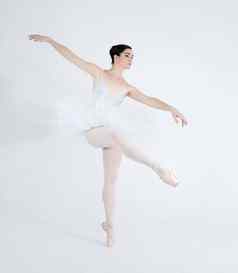 一步表达爱跳舞优雅的年轻的芭蕾舞女演员跳舞尖端白色背景