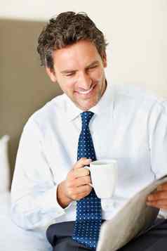咖啡报纸聪明的微笑业务男人。持有杯咖啡阅读报纸