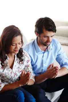 的关系加强信仰年轻的夫妇坐着祈祷