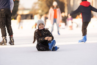 女孩下降了冰<strong>溜冰</strong>场冬天女孩坐在冰<strong>溜冰</strong>鞋秋天
