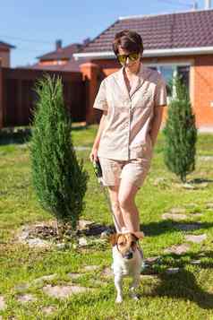 年轻的女人穿睡衣狗后院概念动物友谊宠物老板爱