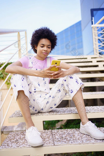 黑色的女人发短信智能<strong>手机</strong>坐着<strong>步骤</strong>现代建筑