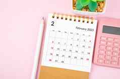 2月桌子上日历一年计算器粉红色的颜色背景