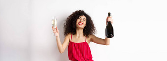 快乐聚会，派对女孩红色的衣服跳舞瓶香槟玻璃喝有趣的庆祝假期站白色背景