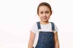 孤立的肖像白色背景令人愉快的婴儿女孩穿蓝色的牛仔布工作服微笑相机